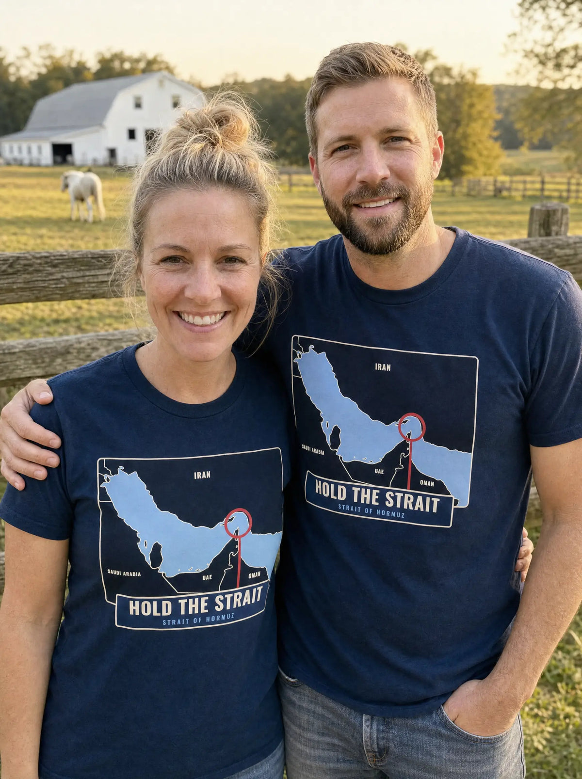 Couple in navy Hold the Strait tees with a Strait of Hormuz map print, standing at a farm fence