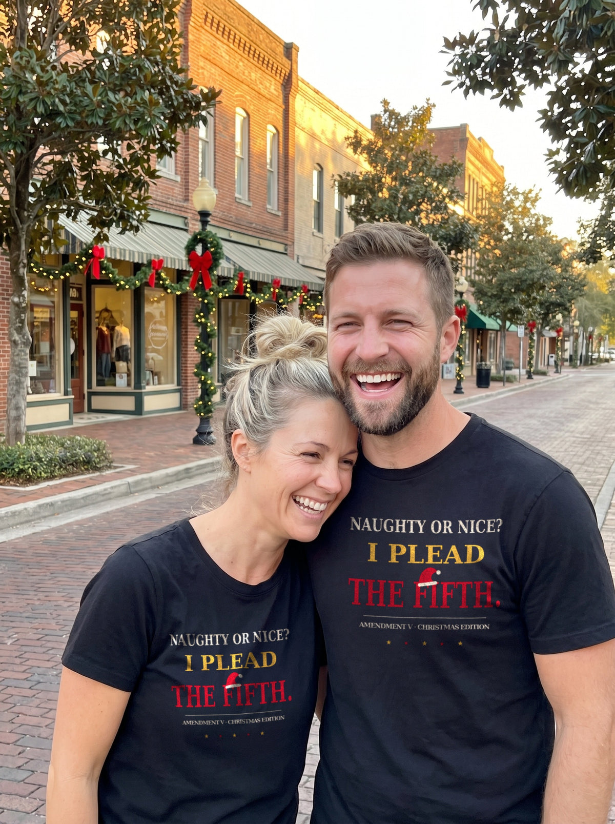 Garrett and Savannah laughing together on a brick downtown street in black "I Plead the Fifth" Christmas Patriot tees