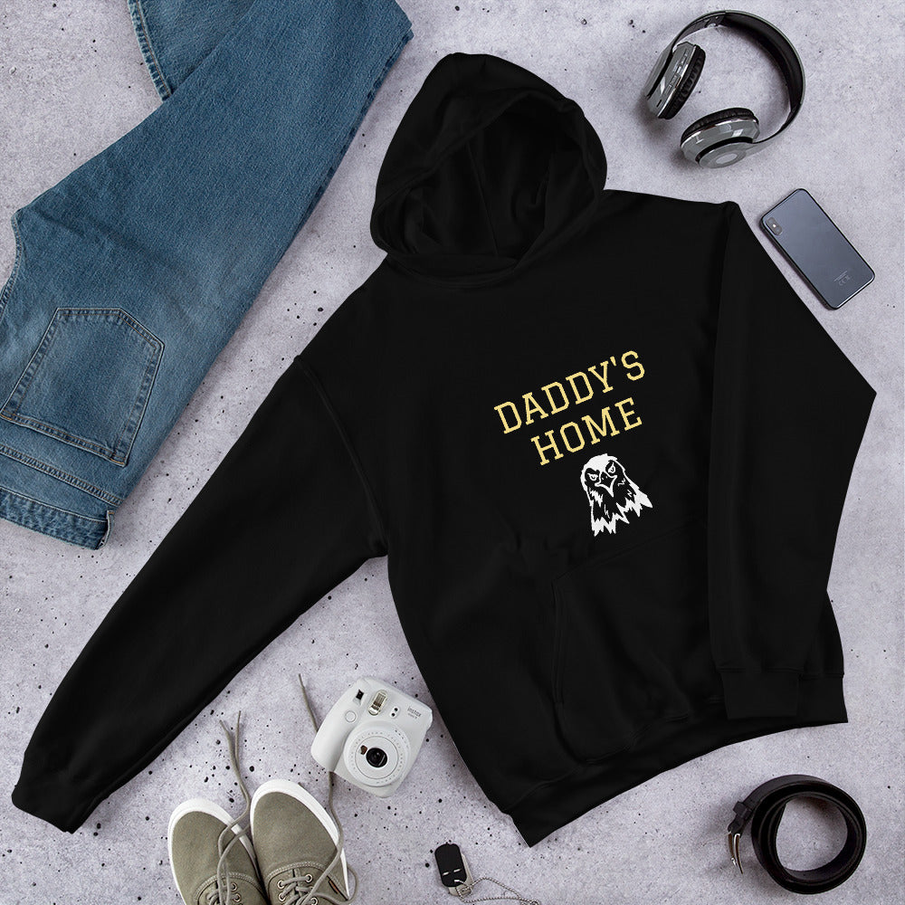 Daddy's Home Vintage Heritage Hoodie in black with gold lettering and eagle, flat lay with jeans and headphones